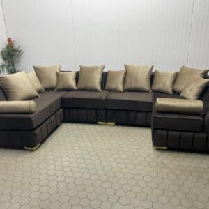 U-Shaped Brown Sofa with Gold Accent Cushions and Bolster Detail